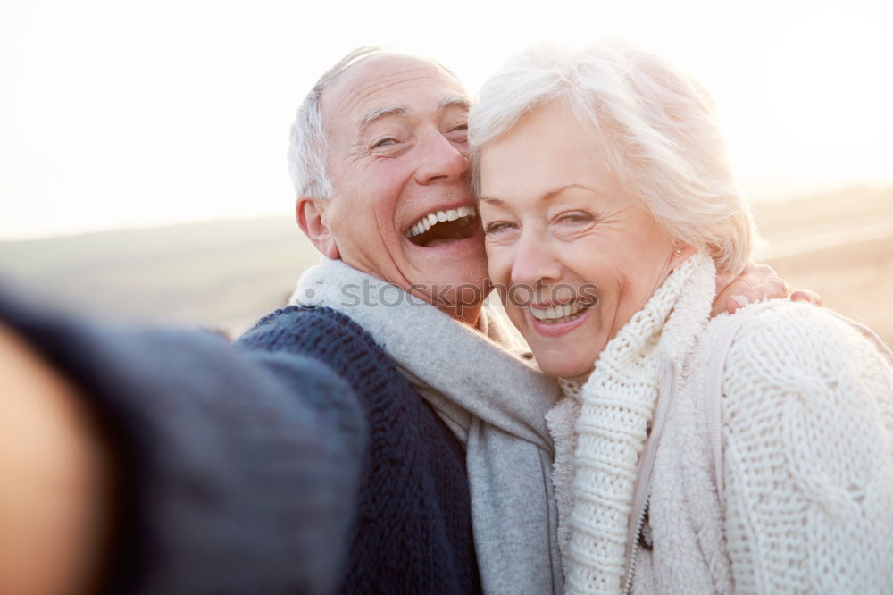 Similar – Image, Stock Photo 2 seniors in love are sitting on a bench in the vineyard and look into the Ahr valley. The man points to something.