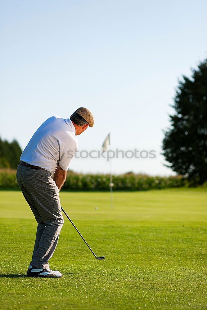 Similar – Golfer performs a golf shot from the fairway