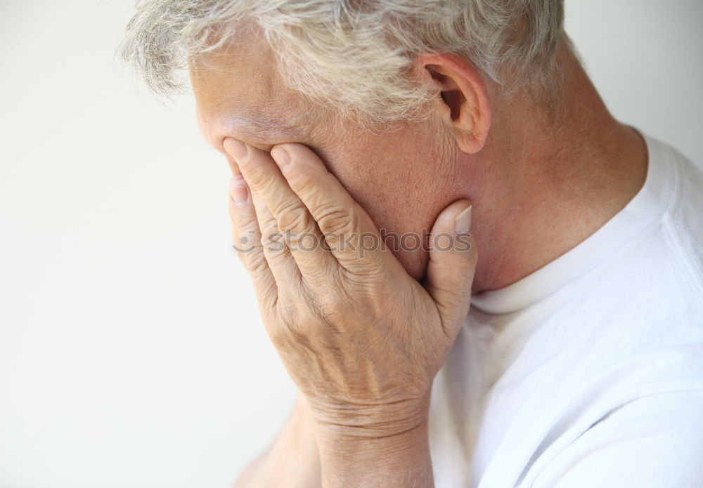 Similar – one sad woman sitting near a wall and holding her head in her hands