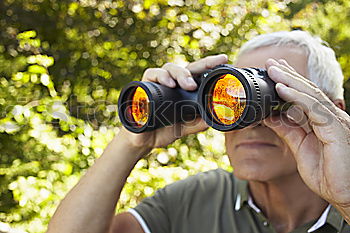 Similar – Foto Bild ein Mann blickt mit einem Fernglas durch einen Zaun