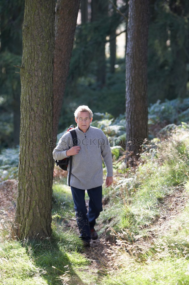 Similar – Happy senior couple on a hike trough green fields