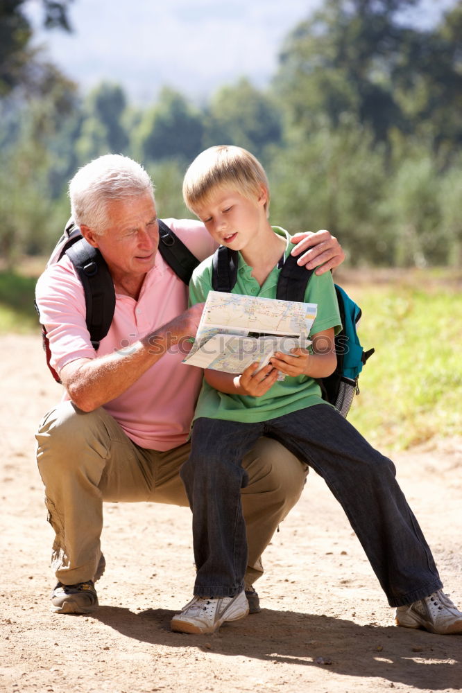 Similar – Image, Stock Photo Senior man and child reading a newspaper outdoors