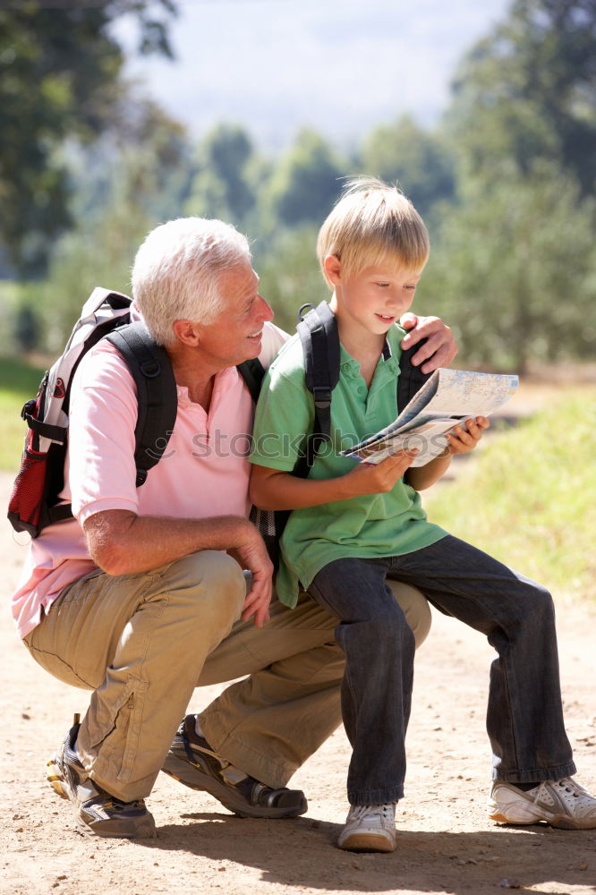 Similar – Image, Stock Photo Senior man and child reading a newspaper outdoors