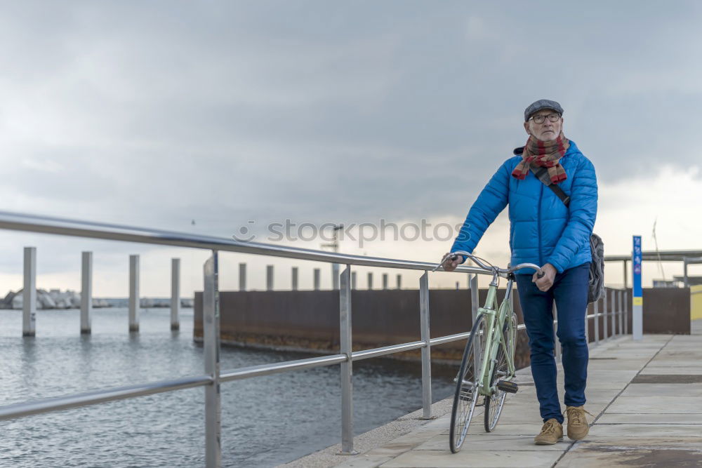 Similar – Image, Stock Photo Portrait senior man walking with his bicycle next to the sea