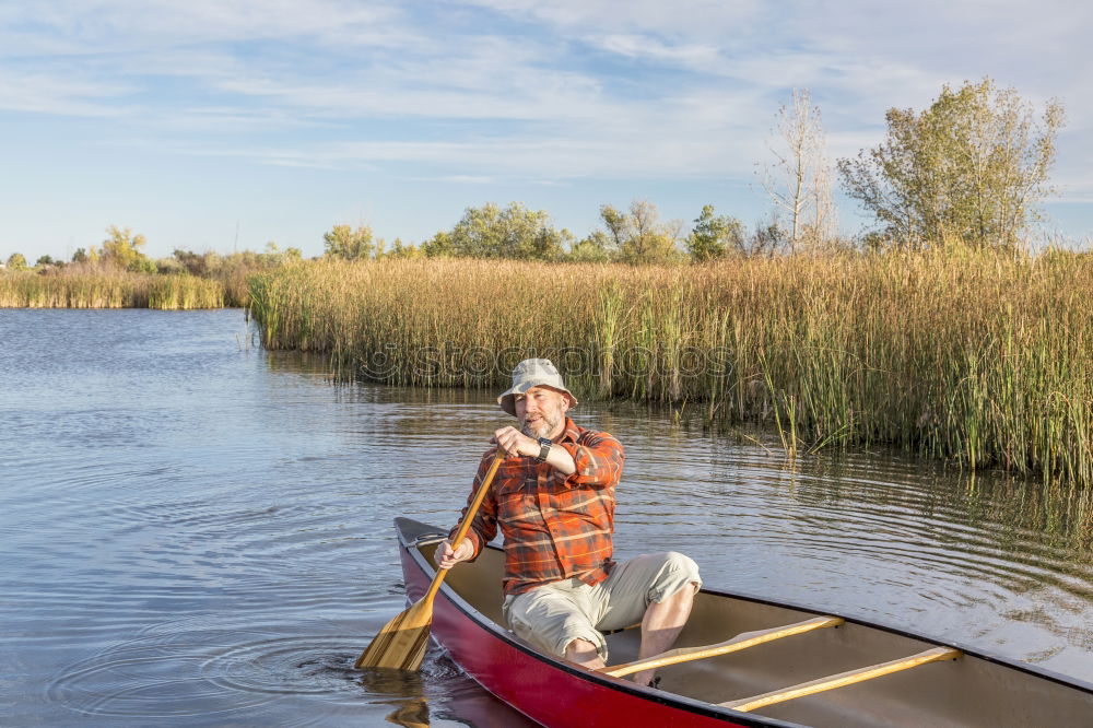 Similar – Image, Stock Photo Woman enjoying the evening sun with a colourful umbrella on a bench in the reeds by the lake