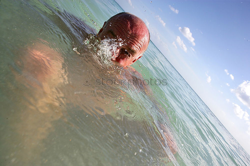 Image, Stock Photo Man in wetsuit swimming in ocean