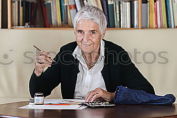 Similar – Image, Stock Photo Elderly woman wearing glasses sitting in her living room reading a letter, closeup portrait