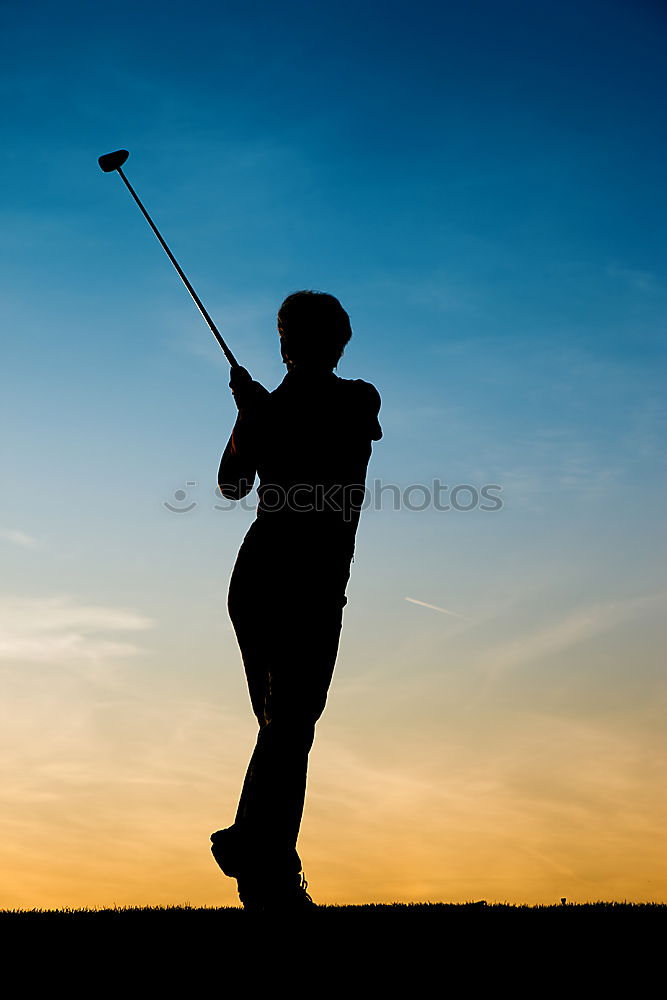 Similar – Golfer performs a golf shot from the fairway