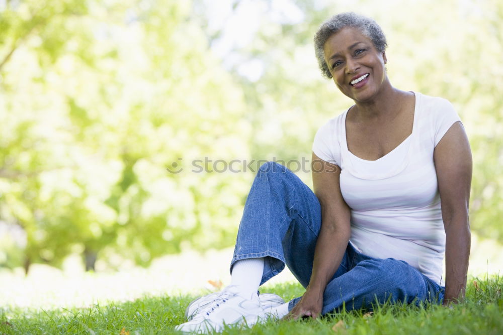 Similar – Mixed woman with afro hairstyle smiling in urban park