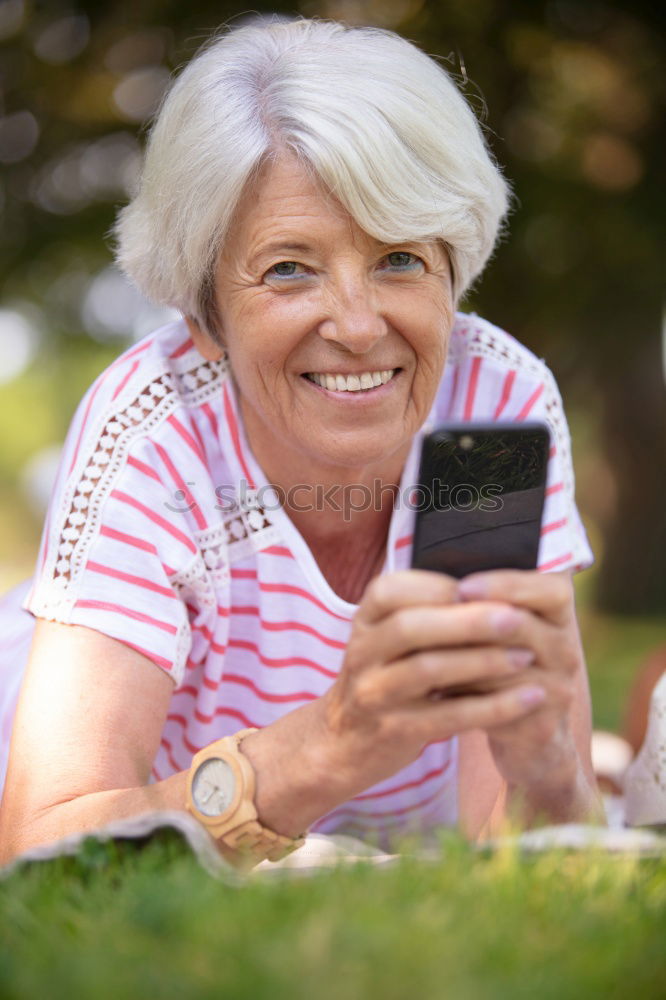 Similar – senior woman using smartphone