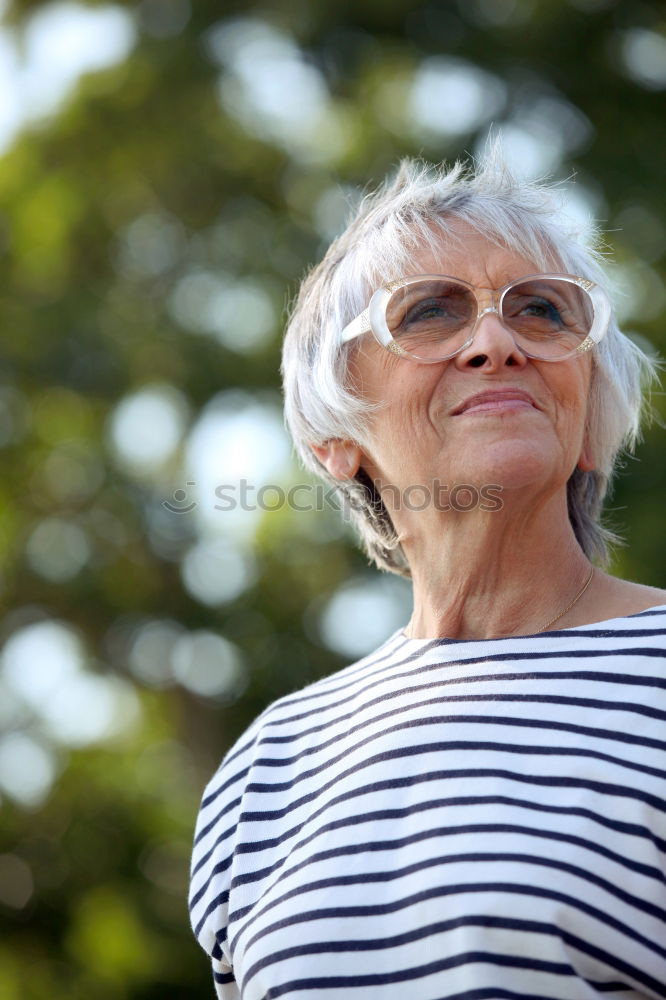 Similar – Image, Stock Photo Senior citizen looks at her smartphone in the autumn forest