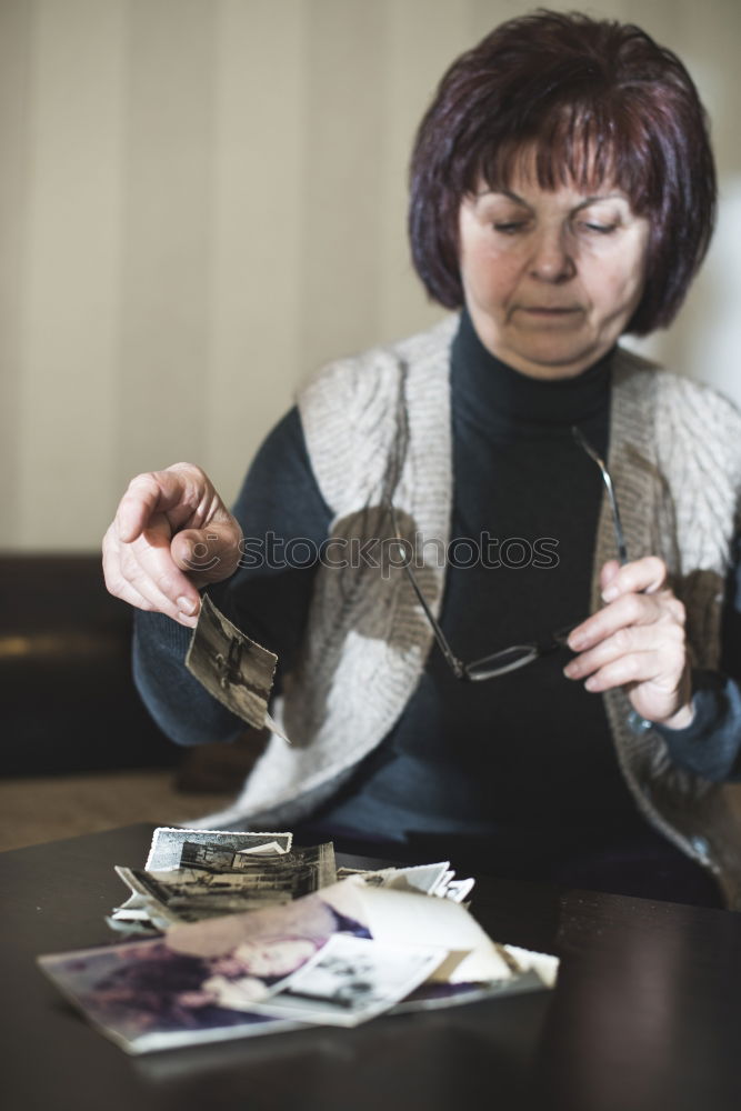 Similar – Image, Stock Photo Elderly woman wearing glasses sitting in her living room reading a letter, closeup portrait