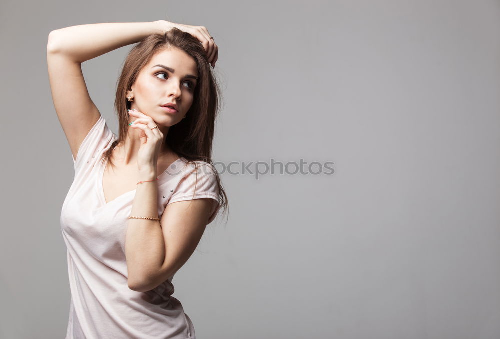 Similar – Young smiling blond woman leaning against wall