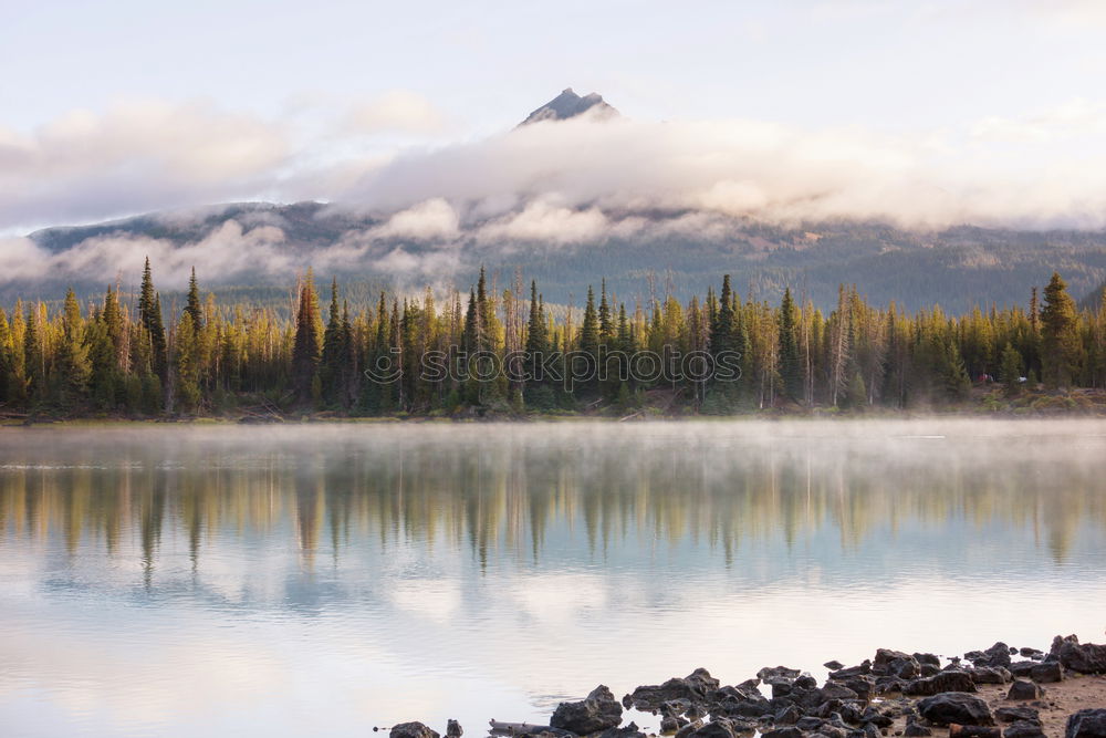 Similar – Image, Stock Photo autumnal lakeside in front of mountains with snow in bad weather with rain clouds