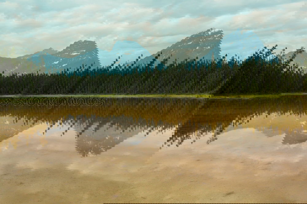 Similar – Image, Stock Photo Symmetry | Mountains reflected in the lake in autumn and with overcast skies with many clouds