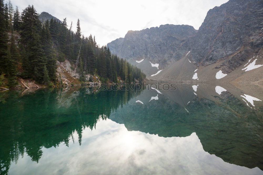 Similar – Mountain lake in coniferous trees