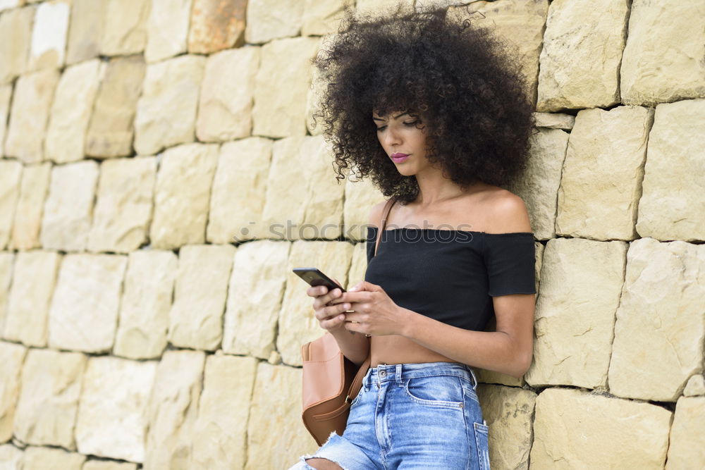Image, Stock Photo Smiling woman looking at her smart phone outdoors