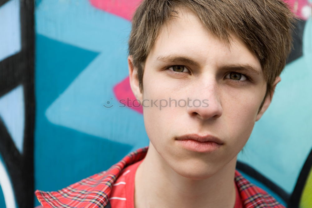 Similar – Portrait of a teenager with hoodie, in front of a red brick wall