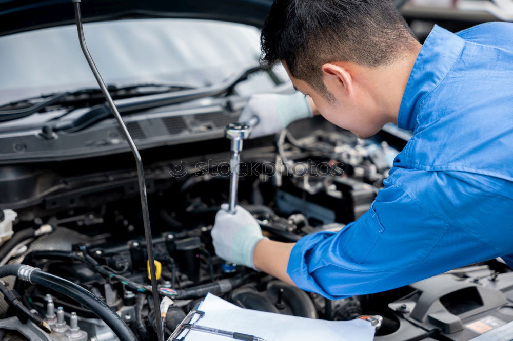 Similar – Professional Mechanic Repairing Car.