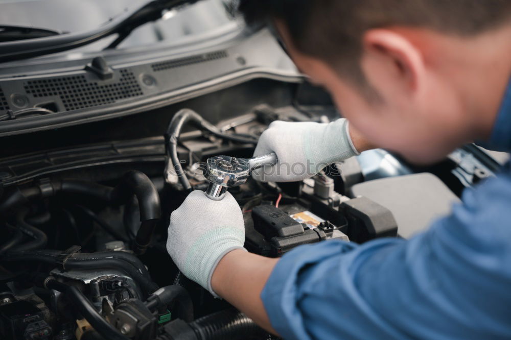 Similar – Professional Mechanic Repairing Car.