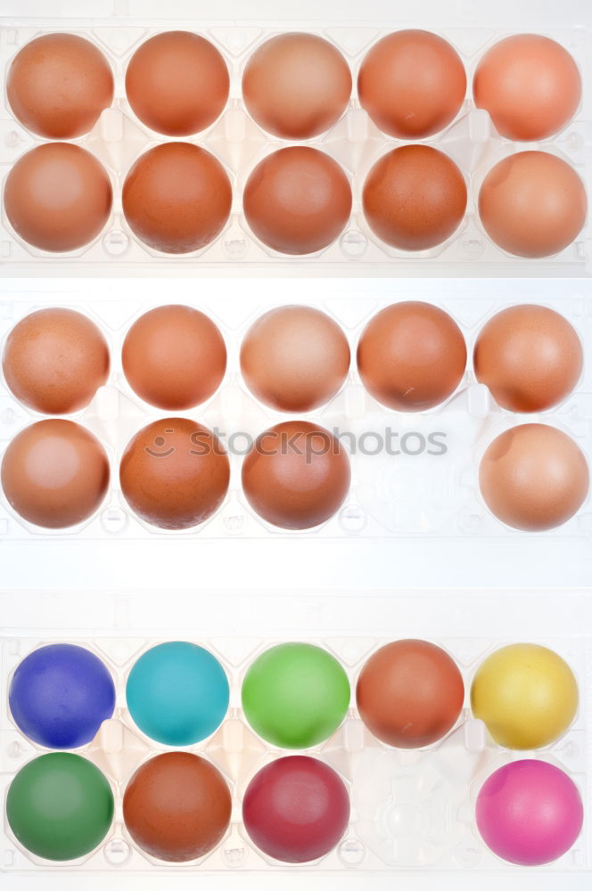 Similar – colorful Easter eggs next to natural brown chicken eggs