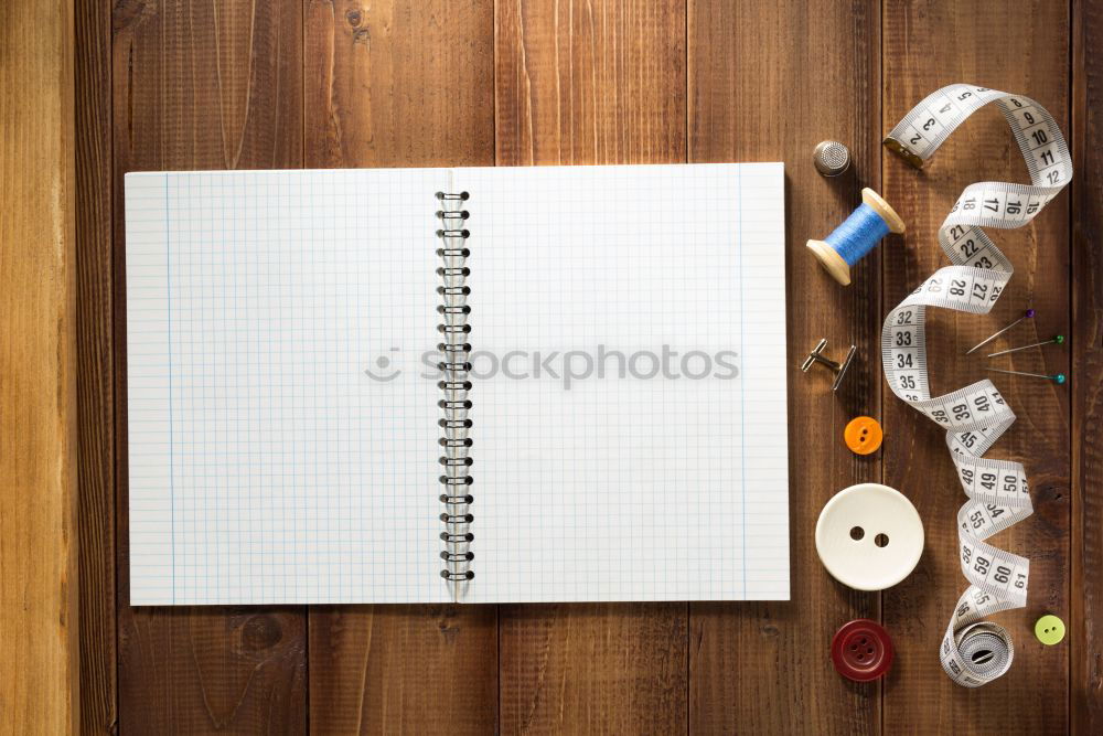 Similar – Red and black desk utensils on a wooden table. notebook, pencils, ruler, tape, sharpener, paper clips, book, stapler