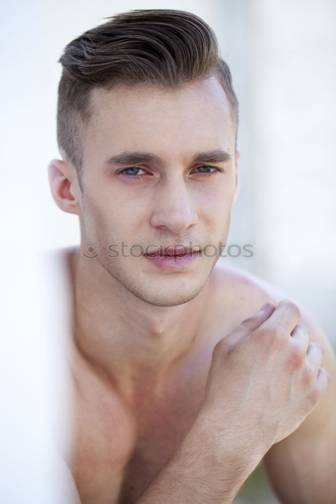 Face of shirtless young man smiling