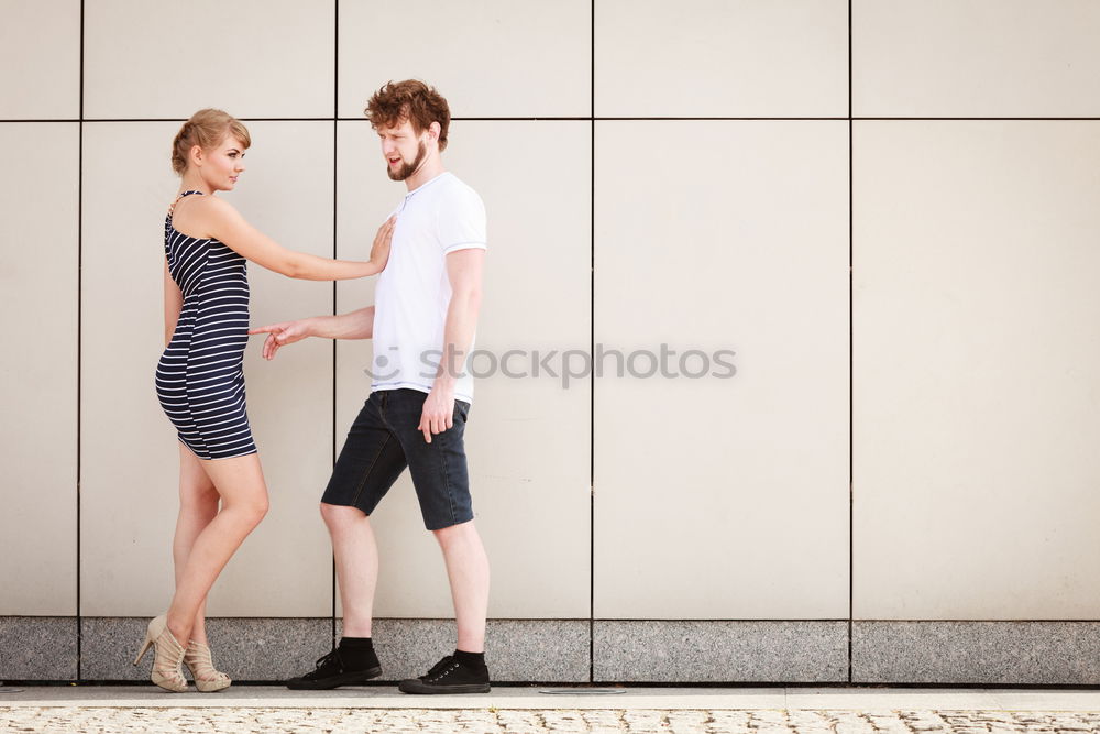 Similar – Side view Happy couple in love jumping against grey wall.