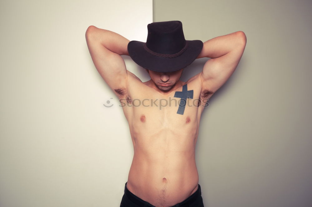 Similar – Image, Stock Photo young man spreads his arms like an angel while leaning against the wall with a tattoo on his bare chest