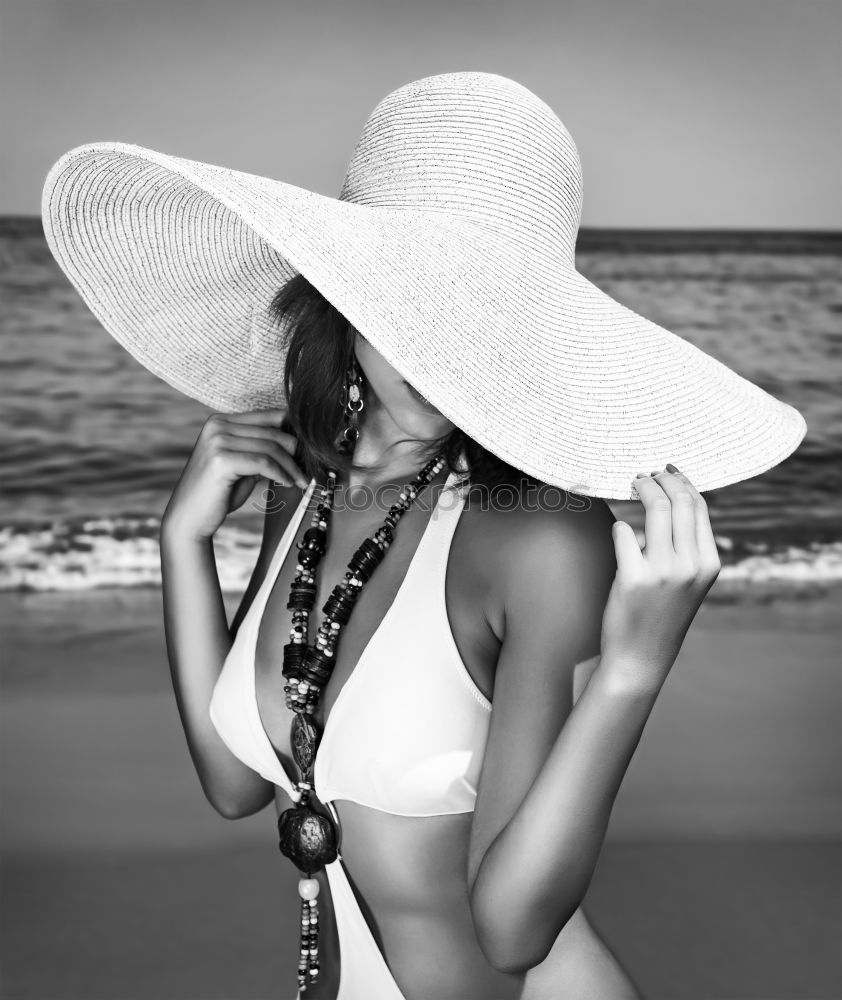 Similar – Woman in swimsuit sitting on grass holding pineapple