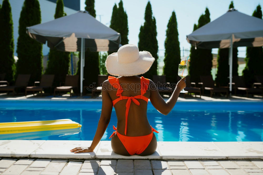 Similar – Image, Stock Photo Black woman lying down in a swimming pool side