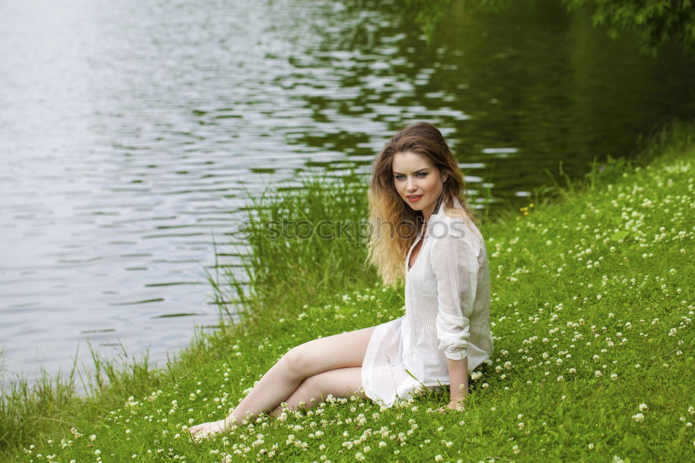 Similar – Image, Stock Photo analog medium format portrait of young woman in summer dress sitting barefoot among bushes in nature on a lakeside