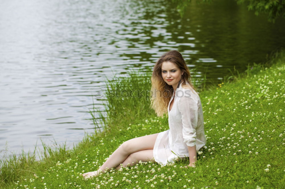 Similar – Image, Stock Photo analog medium format portrait of young woman in summer dress sitting barefoot among bushes in nature on a lakeside