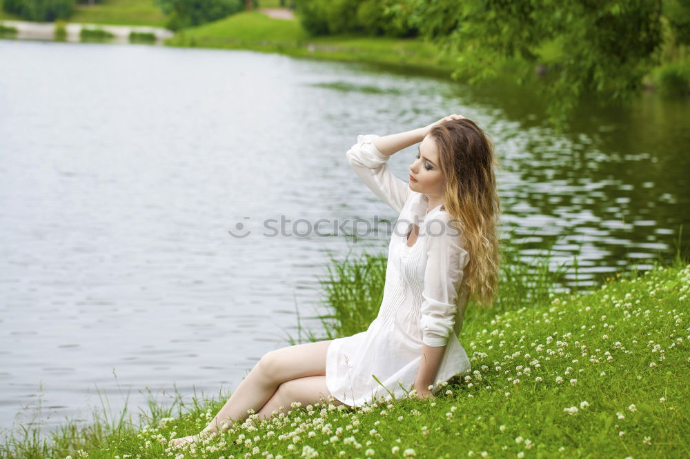 Similar – Image, Stock Photo Girl sitting in front of a lake