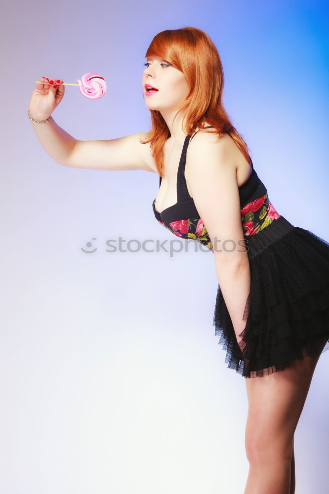 Similar – red-haired woman with black gloves in dotted dress, smiling and interlacing hands behind head