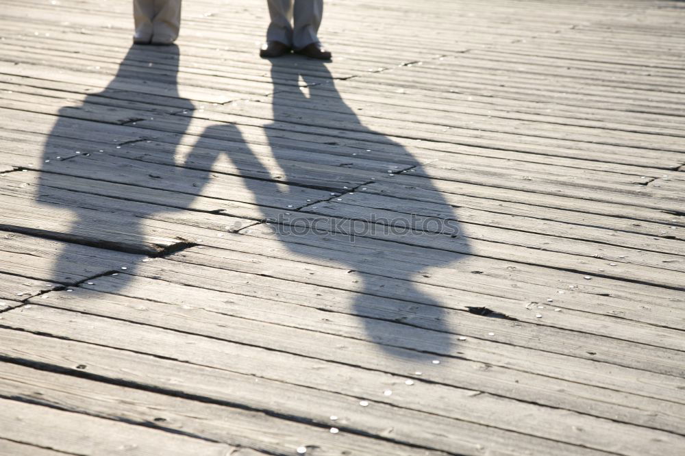 Similar – Schatten von Frau mit Tasche auf Stein