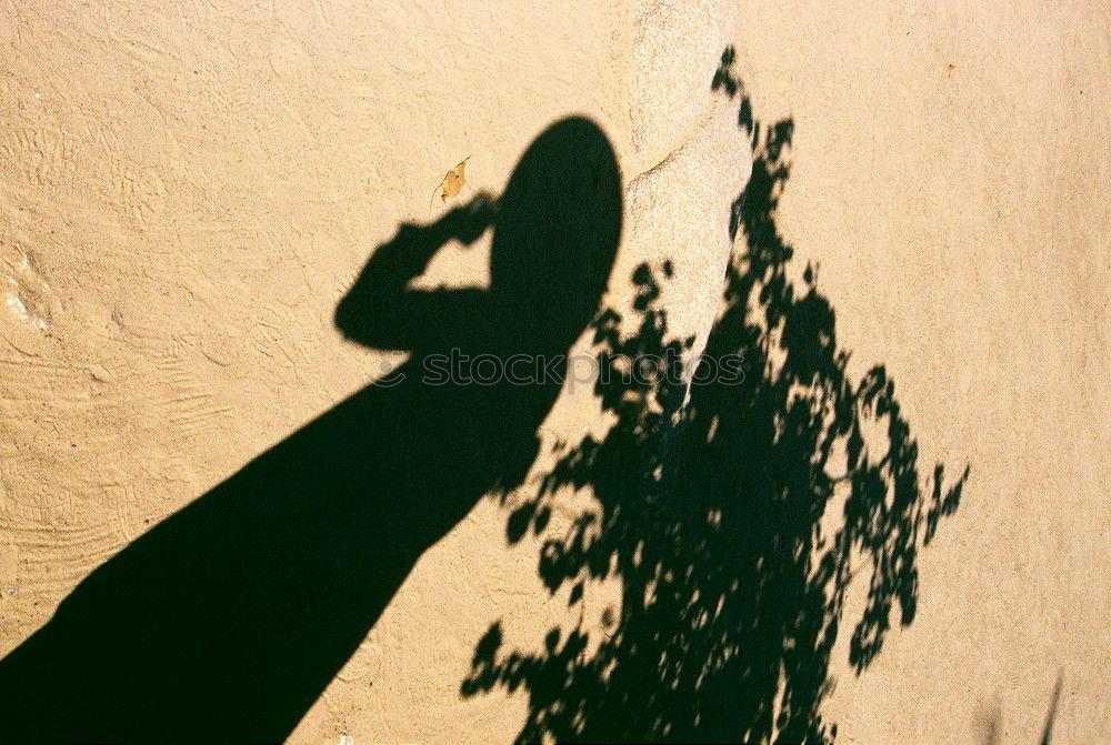 Similar – Schatten von Frau mit Tasche auf Stein