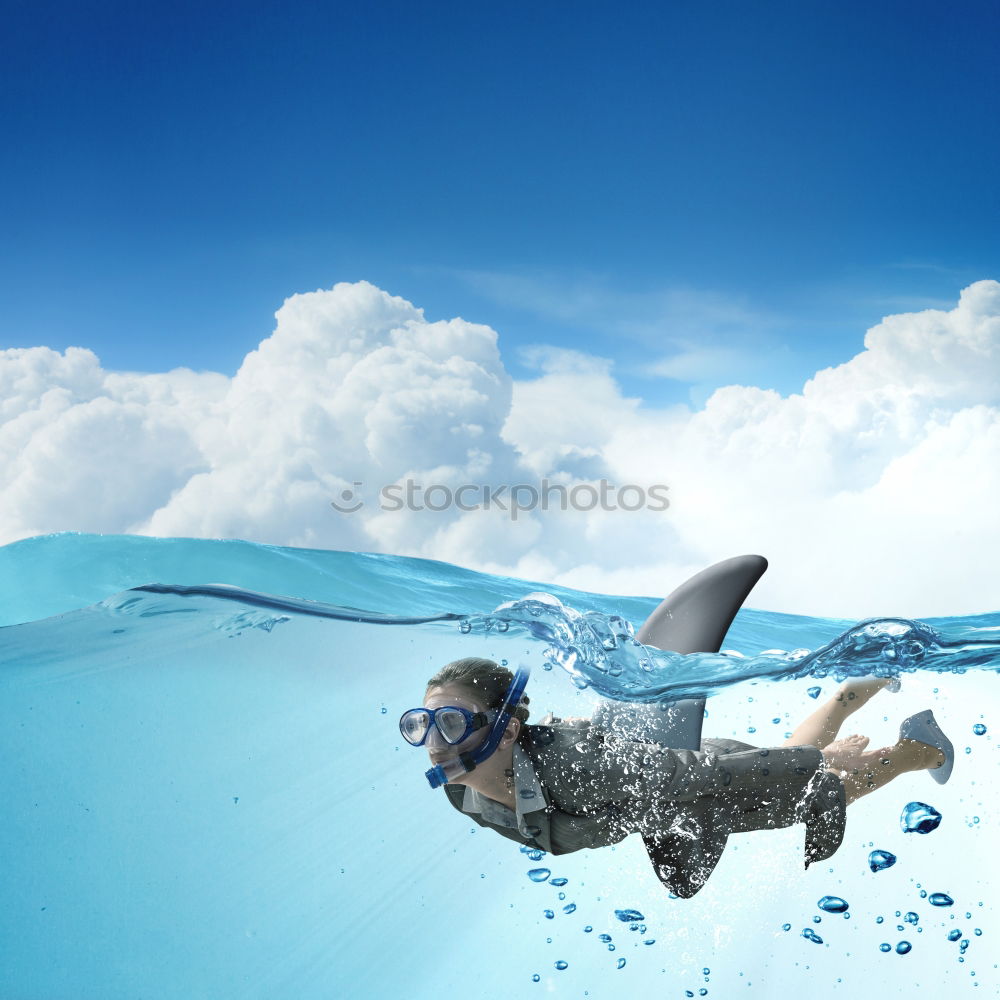 Similar – Woman in goggles swimming undersea and looking at camera