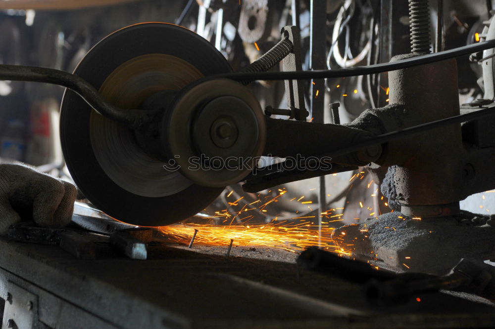 Similar – Unrecognizable worker cutting metal in garage