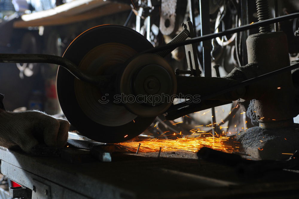 Similar – Unrecognizable worker cutting metal in garage