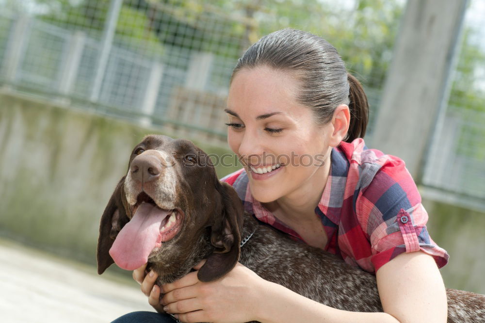 Similar – young woman with long brunette hair squats smiling on a meadow and looks at her dog