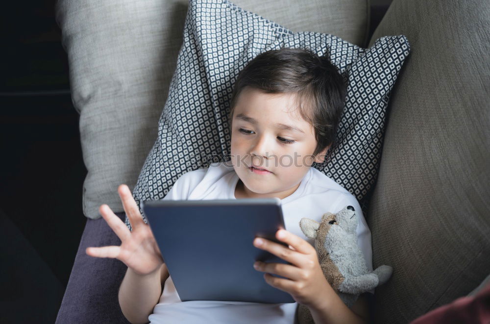 Similar – Mother reading a book to her baby son