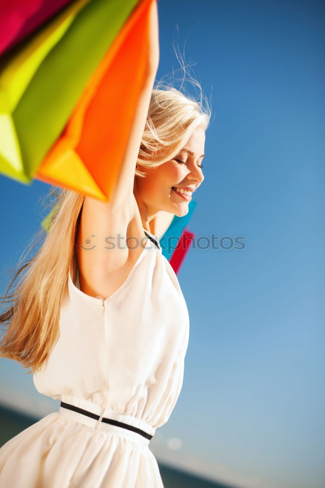 Young happy woman holding a heart shaped balloon