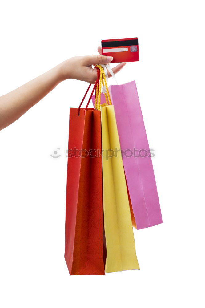 Shopping bags on womans hand. Woman shopping with colored paper bags.