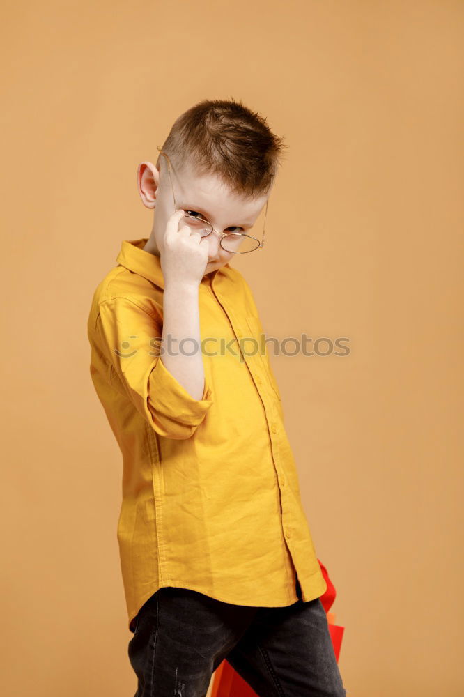 Similar – Cheerful child standing with his backpack on the floor