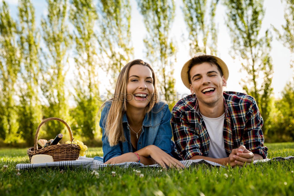 Similar – Beautiful young couple laying on grass in an urban park