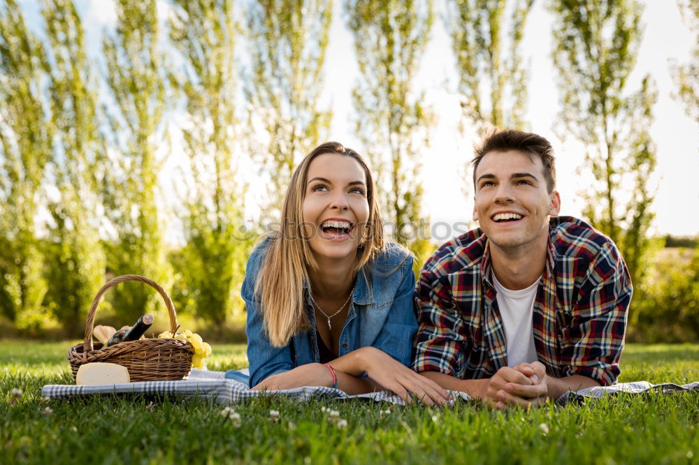 Similar – Beautiful young couple laying on grass in an urban park