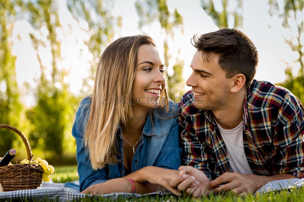 Similar – Beautiful young couple laying on grass in an urban park