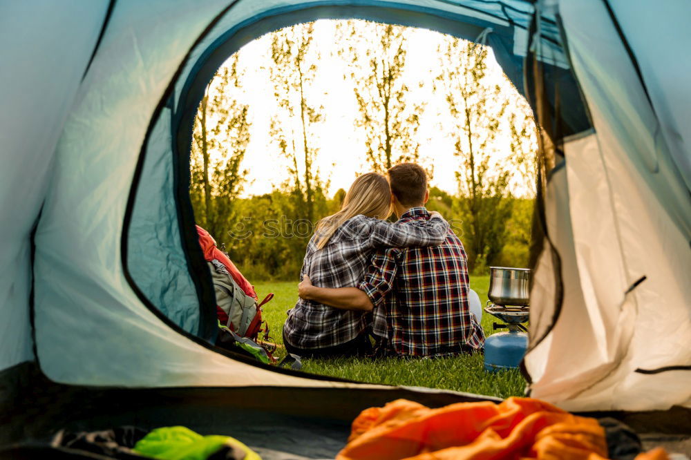 Similar – Couple planning next trip while sitting with map in tent. People relaxing in tent at camping during summer vacation