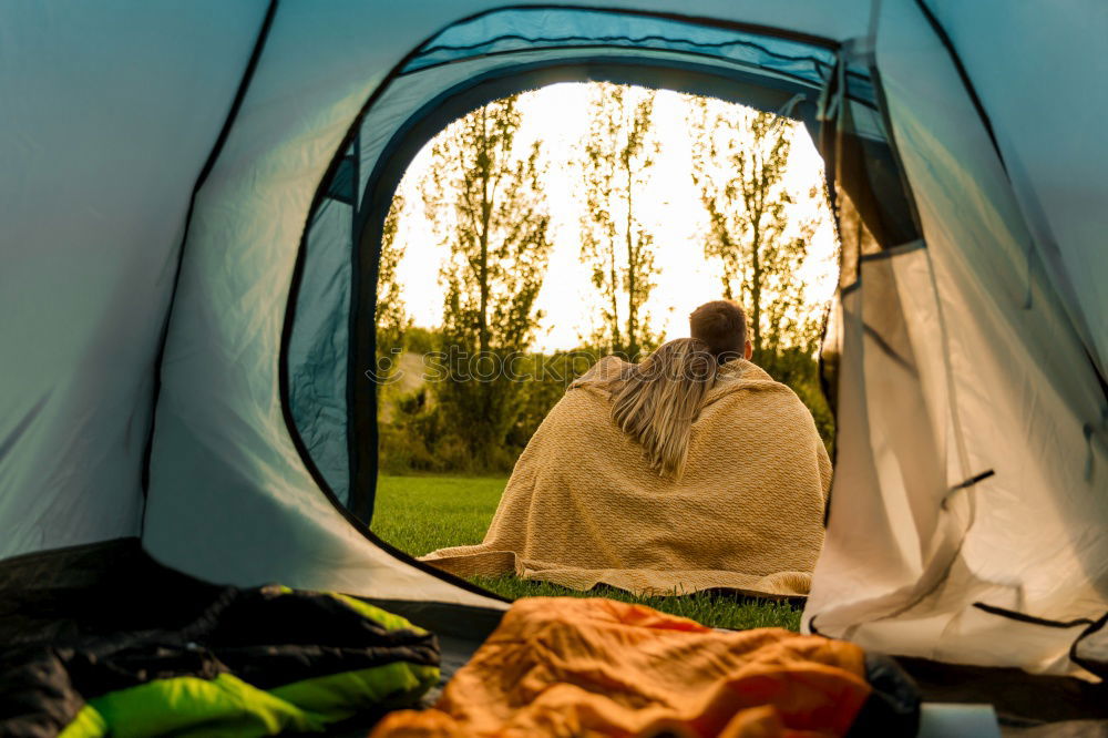 Similar – Couple planning next trip while sitting with map in tent. People relaxing in tent at camping during summer vacation